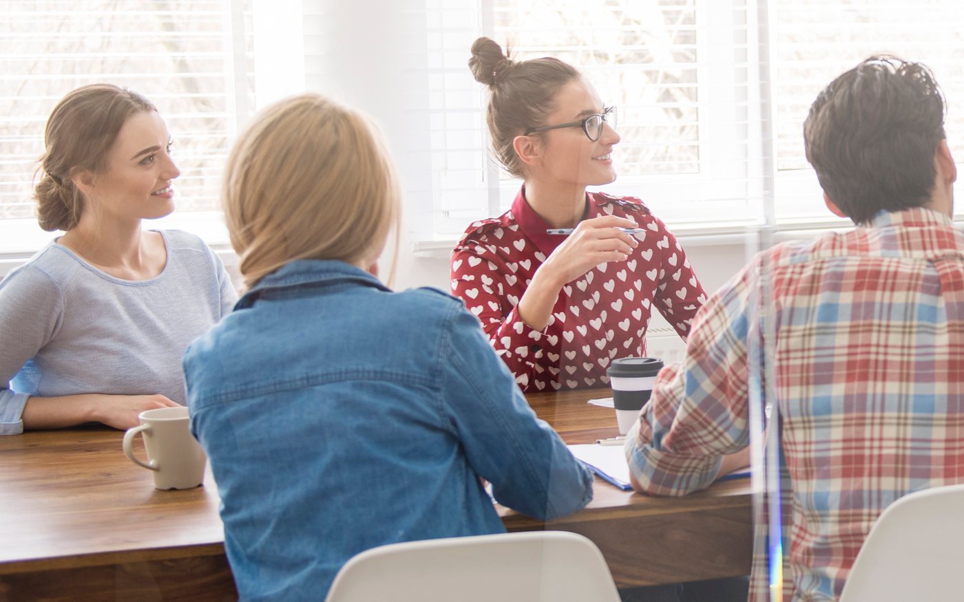 Colleagues around a meeting table during a staff workshop
